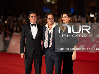 Riccardo Scamarcio, Johnny Depp, and Luisa Ranieri attend the ''Modi - Three Days On The Wing Of Madness'' red carpet during the 19th Rome F...