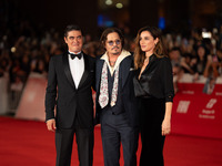 Riccardo Scamarcio, Johnny Depp, and Luisa Ranieri attend the ''Modi - Three Days On The Wing Of Madness'' red carpet during the 19th Rome F...