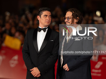 Riccardo Scamarcio and Johnny Depp attend the ''Modi - Three Days On The Wing Of Madness'' red carpet during the 19th Rome Film Festival at...