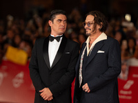 Riccardo Scamarcio and Johnny Depp attend the ''Modi - Three Days On The Wing Of Madness'' red carpet during the 19th Rome Film Festival at...