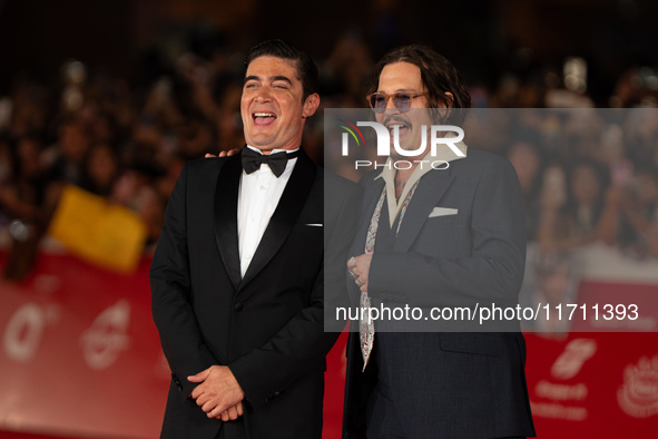 Riccardo Scamarcio and Johnny Depp attend the ''Modi - Three Days On The Wing Of Madness'' red carpet during the 19th Rome Film Festival at...