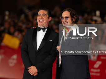 Riccardo Scamarcio and Johnny Depp attend the ''Modi - Three Days On The Wing Of Madness'' red carpet during the 19th Rome Film Festival at...