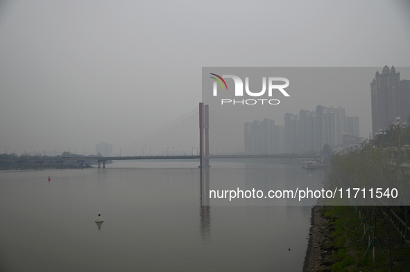 A photo taken on October 26, 2024, shows the bank of the Songhua River under smog in Jilin City, Jilin Province, China. 