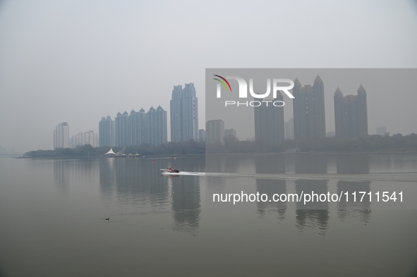 A photo taken on October 26, 2024, shows the bank of the Songhua River under smog in Jilin City, Jilin Province, China. 