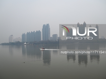 A photo taken on October 26, 2024, shows the bank of the Songhua River under smog in Jilin City, Jilin Province, China. (