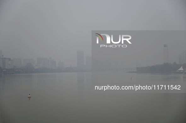 A photo taken on October 26, 2024, shows the bank of the Songhua River under smog in Jilin City, Jilin Province, China. 