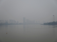 A photo taken on October 26, 2024, shows the bank of the Songhua River under smog in Jilin City, Jilin Province, China. (