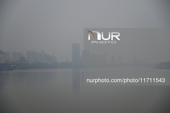 A photo taken on October 26, 2024, shows the bank of the Songhua River under smog in Jilin City, Jilin Province, China. 