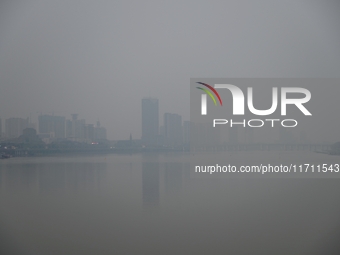 A photo taken on October 26, 2024, shows the bank of the Songhua River under smog in Jilin City, Jilin Province, China. (