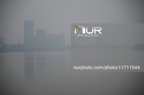 A photo taken on October 26, 2024, shows the bank of the Songhua River under smog in Jilin City, Jilin Province, China. 