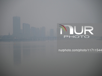 A photo taken on October 26, 2024, shows the bank of the Songhua River under smog in Jilin City, Jilin Province, China. (