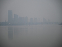 A photo taken on October 26, 2024, shows the bank of the Songhua River under smog in Jilin City, Jilin Province, China. (