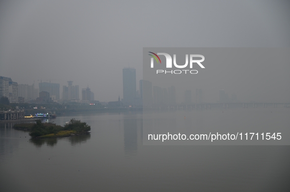 A photo taken on October 26, 2024, shows the bank of the Songhua River under smog in Jilin City, Jilin Province, China. 