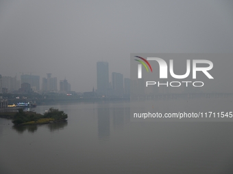 A photo taken on October 26, 2024, shows the bank of the Songhua River under smog in Jilin City, Jilin Province, China. (