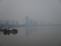 A photo taken on October 26, 2024, shows the bank of the Songhua River under smog in Jilin City, Jilin Province, China. (