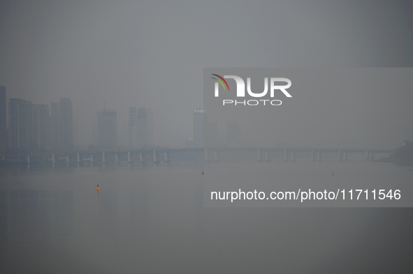 A photo taken on October 26, 2024, shows the bank of the Songhua River under smog in Jilin City, Jilin Province, China. 