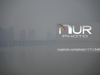 A photo taken on October 26, 2024, shows the bank of the Songhua River under smog in Jilin City, Jilin Province, China. (