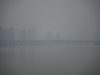 A photo taken on October 26, 2024, shows the bank of the Songhua River under smog in Jilin City, Jilin Province, China. (