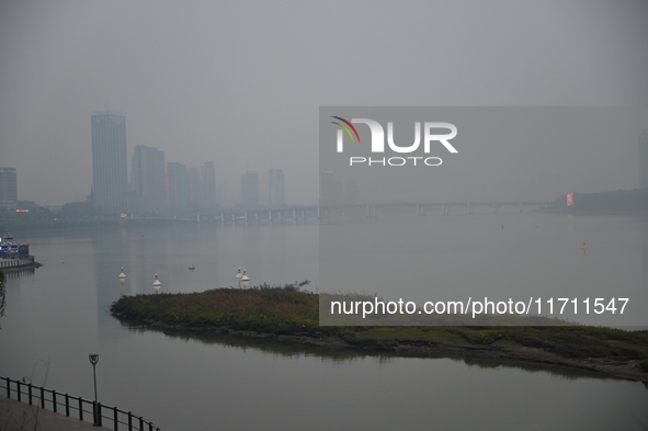 A photo taken on October 26, 2024, shows the bank of the Songhua River under smog in Jilin City, Jilin Province, China. 