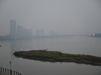 A photo taken on October 26, 2024, shows the bank of the Songhua River under smog in Jilin City, Jilin Province, China. (