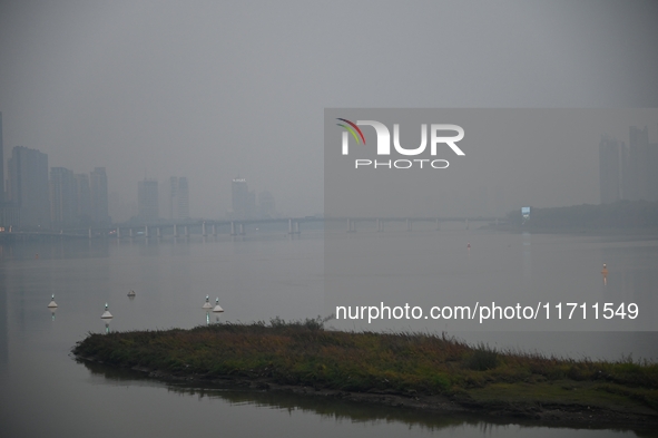 A photo taken on October 26, 2024, shows the bank of the Songhua River under smog in Jilin City, Jilin Province, China. 