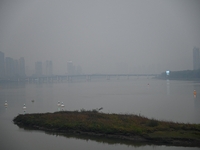 A photo taken on October 26, 2024, shows the bank of the Songhua River under smog in Jilin City, Jilin Province, China. (