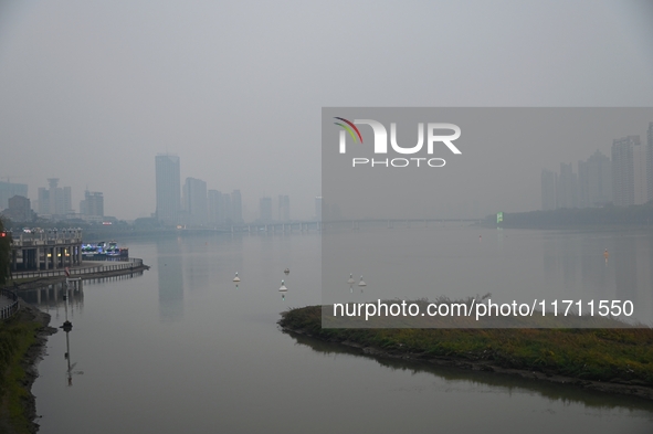 A photo taken on October 26, 2024, shows the bank of the Songhua River under smog in Jilin City, Jilin Province, China. 