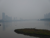 A photo taken on October 26, 2024, shows the bank of the Songhua River under smog in Jilin City, Jilin Province, China. (