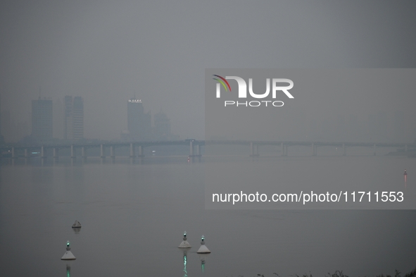 A photo taken on October 26, 2024, shows the bank of the Songhua River under smog in Jilin City, Jilin Province, China. 