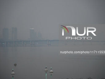 A photo taken on October 26, 2024, shows the bank of the Songhua River under smog in Jilin City, Jilin Province, China. (