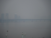 A photo taken on October 26, 2024, shows the bank of the Songhua River under smog in Jilin City, Jilin Province, China. (