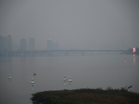 A photo taken on October 26, 2024, shows the bank of the Songhua River under smog in Jilin City, Jilin Province, China. (