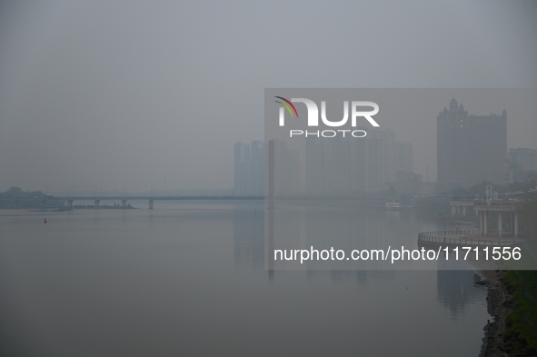 A photo taken on October 26, 2024, shows the bank of the Songhua River under smog in Jilin City, Jilin Province, China. 