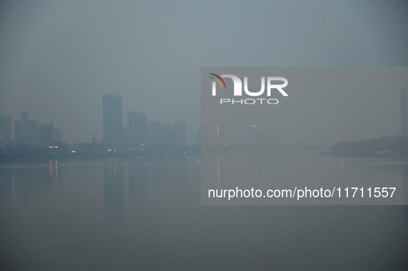 A photo taken on October 26, 2024, shows the bank of the Songhua River under smog in Jilin City, Jilin Province, China. 