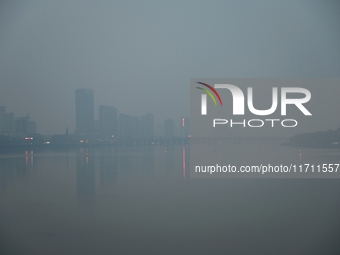 A photo taken on October 26, 2024, shows the bank of the Songhua River under smog in Jilin City, Jilin Province, China. (