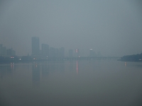 A photo taken on October 26, 2024, shows the bank of the Songhua River under smog in Jilin City, Jilin Province, China. (