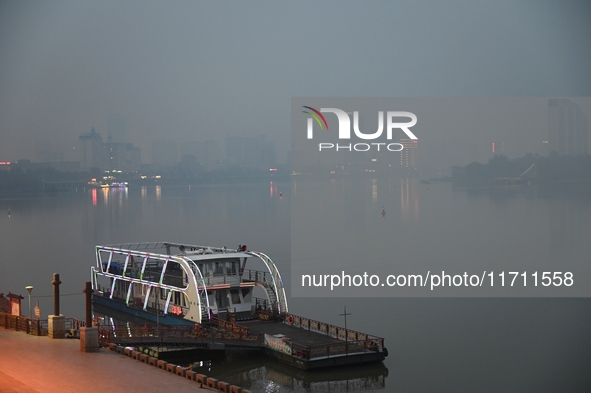 A photo taken on October 26, 2024, shows the bank of the Songhua River under smog in Jilin City, Jilin Province, China. 