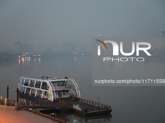 A photo taken on October 26, 2024, shows the bank of the Songhua River under smog in Jilin City, Jilin Province, China. (