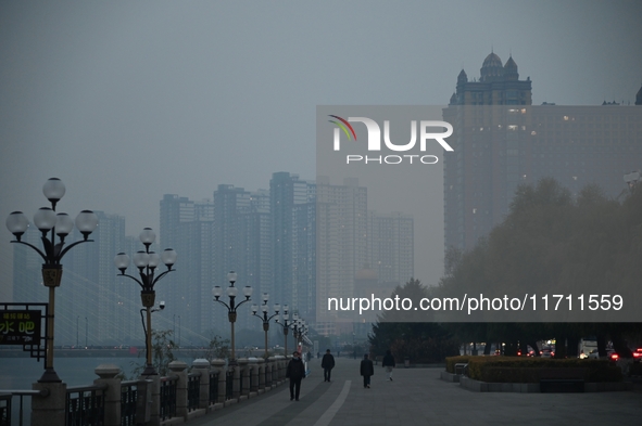 A photo taken on October 26, 2024, shows the bank of the Songhua River under smog in Jilin City, Jilin Province, China. 