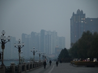 A photo taken on October 26, 2024, shows the bank of the Songhua River under smog in Jilin City, Jilin Province, China. (