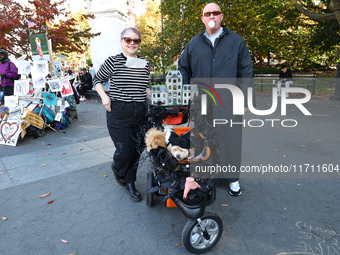 Teresa and Danny from New York City and their dogs, Willow and Sadie, dress as characters from the ''Adams Family'' for the Washington Squar...