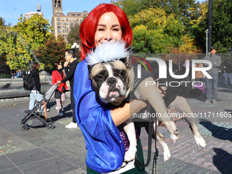 Nina from New York City and her French bulldog Franklin dress as characters from the Little Mermaid for the Washington Square Park Halloween...