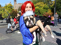 Nina from New York City and her French bulldog Franklin dress as characters from the Little Mermaid for the Washington Square Park Halloween...