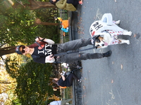 Amanda from East Harlem holds Don Julio, an Australian Shepherd who is dressed as a New York City cup of coffee for the Washington Square Pa...