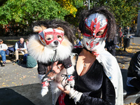 Tintin from Colombia and her dog Tintin dress as Lucha libre wrestlers for the Washington Square Park Halloween Dog Parade in New York, N.Y....