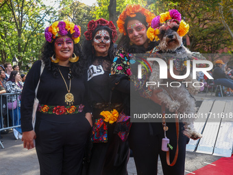 These women and their dog dress as La Calavera Catrina, a symbol of the Day of the Dead, for the Washington Square Park Halloween Dog Parade...