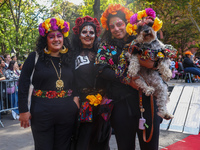 These women and their dog dress as La Calavera Catrina, a symbol of the Day of the Dead, for the Washington Square Park Halloween Dog Parade...