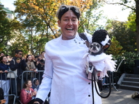 A man dresses as Victor Frankenstein and holds his dog, which is dressed as the Bride of Frankenstein, during the Washington Square Park Hal...