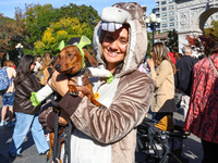 Scarlett from Manhattan has her dog Hamilton, a dachshund, dressed in a costume at the Washington Square Park Halloween Dog Parade in New Yo...