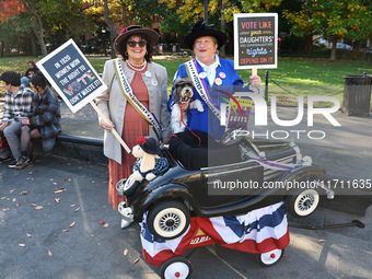 Lynn from Paramus and Kathy from Woodridge, N.J., with their dog Avery Finn, pose for a photo during the Washington Square Park Halloween Do...